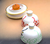 A set of two tajine inspired gold flaked butter dishes