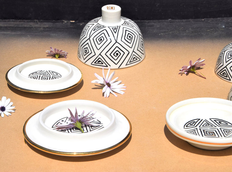 A set of three black, white and gold tajine inspired butter dishes
