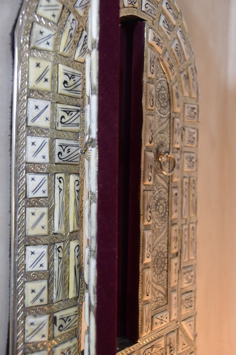 Amazingly detailed metal and bone mirror