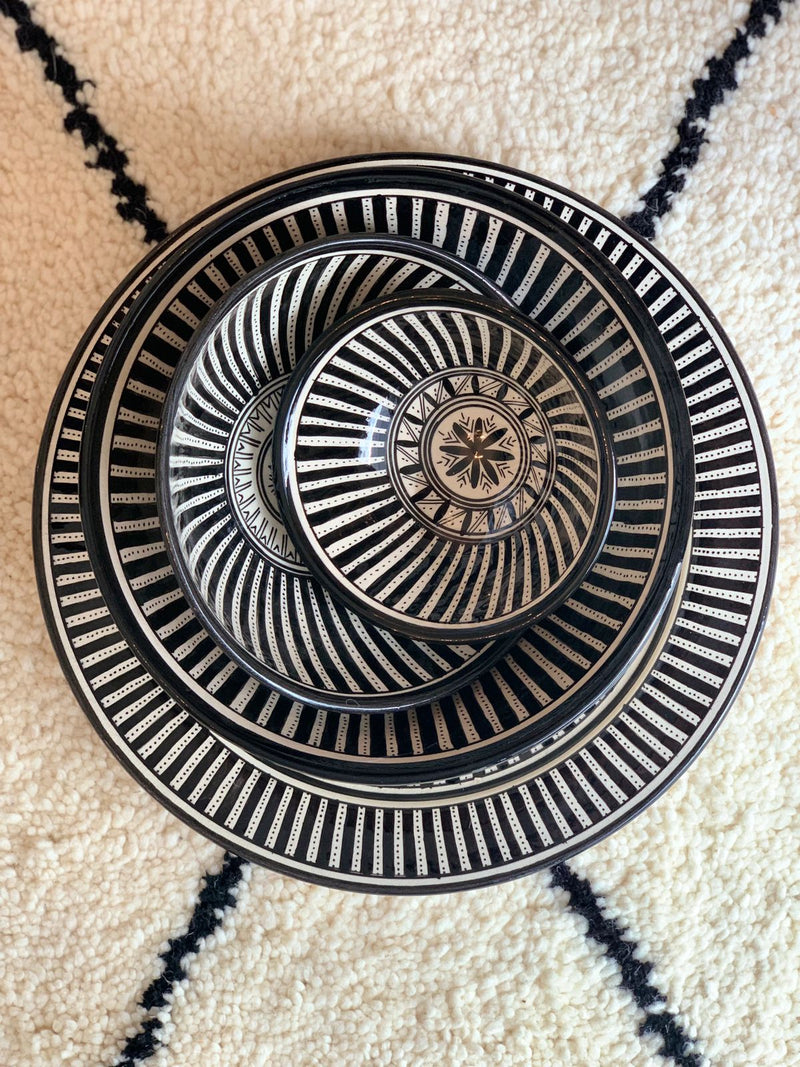 A set of three stunning and intricate black and white bowls and a plate