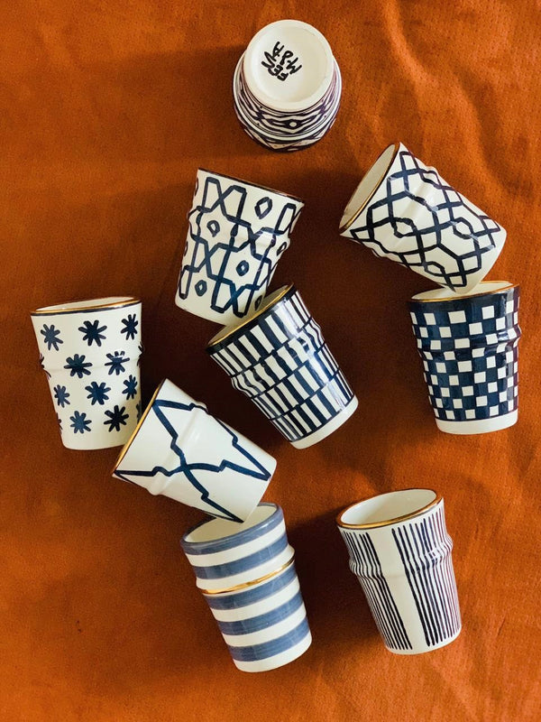 A set of ten Beldi Cups in shades of blue rimmed with gold