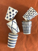 A set of ten Beldi Cups in shades of blue rimmed with gold